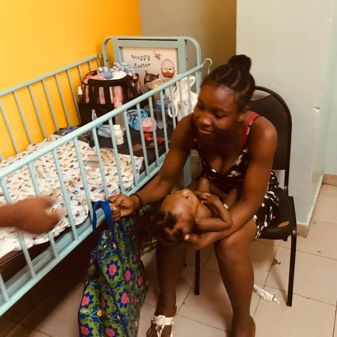 Mother receiving a kit while caring for her baby in the hospital room