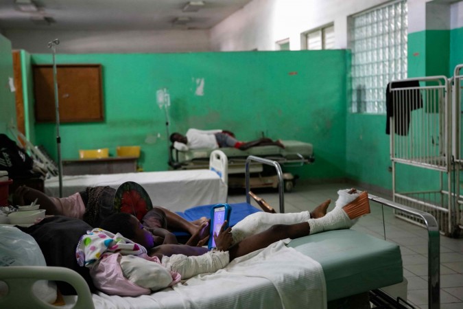 Patient with a bandaged leg in a Haitian hospital ward